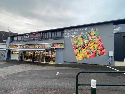 a store with a picture of fruit on the side of it at L’odon in Caen