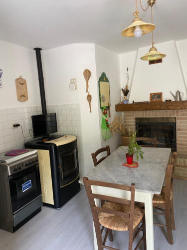 a kitchen with a table and a stove at Casa rio Lera in Amandola