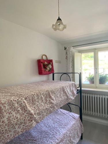 a bedroom with a bed and a window at Casa rio Lera in Amandola