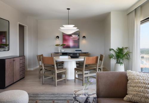 a kitchen and dining room with a table and chairs at Kimpton Claret Hotel by IHG in Denver