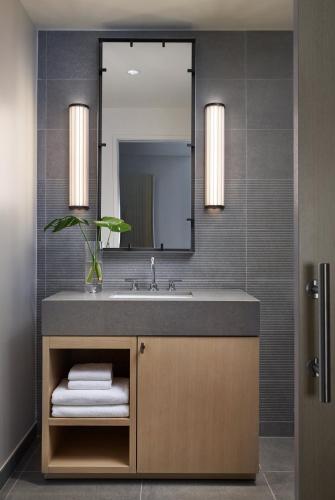 a bathroom with a sink and a mirror at Kimpton Claret Hotel by IHG in Denver