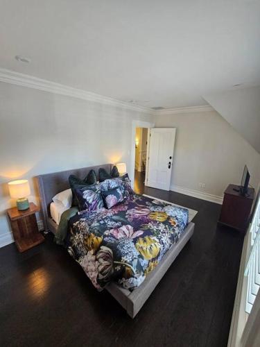 a bedroom with a large bed in a room at IODE Clark House Top Floor Apartment in Fredericton