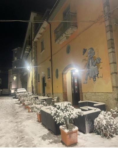 a building with a painting on the side of it in the snow at Perbacco in SantʼAngelo Limosano
