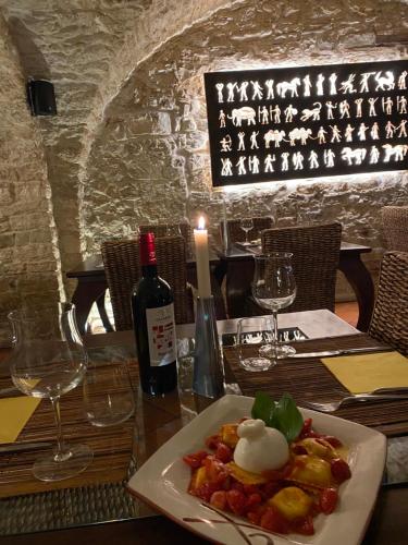 a plate of food on a table with a bottle of wine at Perbacco in SantʼAngelo Limosano