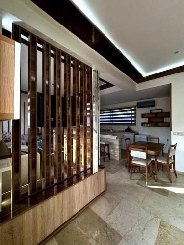 a living room with a table and a dining room at Jnane Jawhara Skhirat house in Skhirat