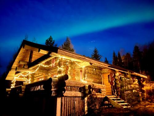 a log cabin with christmas lights on it at Ruka View at the Slopes Ski in, Family & Bike Park, National Park, hike trails - Lapland Villas in Ruka