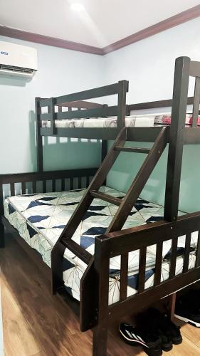 two bunk beds in a room with shoes on the floor at JB Home sweet home Perfect for Family & Friends in Babag