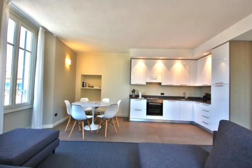 a kitchen and dining room with a table and chairs at Liszt Tower by KlabHouse in Bellagio