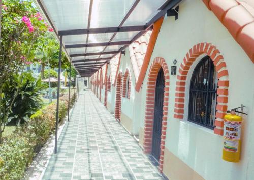 a building with awning over a walkway at Hotel Las Victorias Palmira in Palmira
