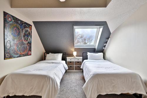 キリングトンにあるMountain Views at Mt Green 2BR-2BA, Shuttle, Discounted Lifts, Pool, Hot Tub and More!の窓のある小さな部屋にベッドが2つある