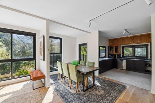 a kitchen and dining room with a table and chairs at Station Penthouse with Private Spa in Warburton