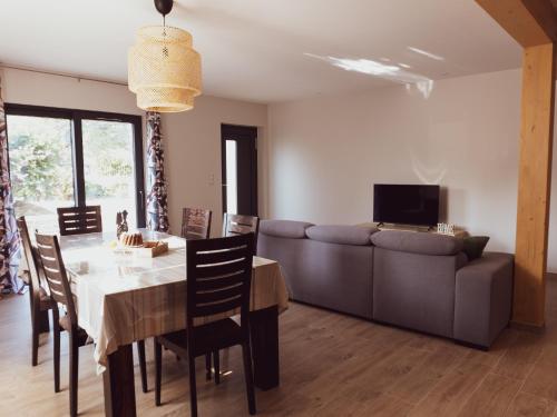 un salon avec une table et un canapé dans l'établissement Le Jardin de Buna - proche Europa Park, à Schoenau