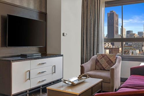 a living room with a tv and a couch at Club Wyndham Canterbury in San Francisco