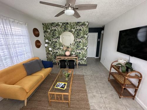 a living room with a couch and a table at Miami's Cozy Tropical Getaway in Miami