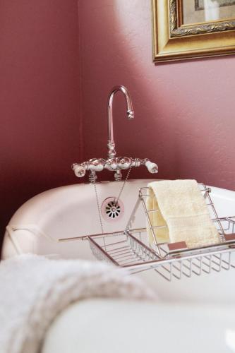 a bathroom with a sink with a faucet and towels at Weaverville Hotel in Weaverville