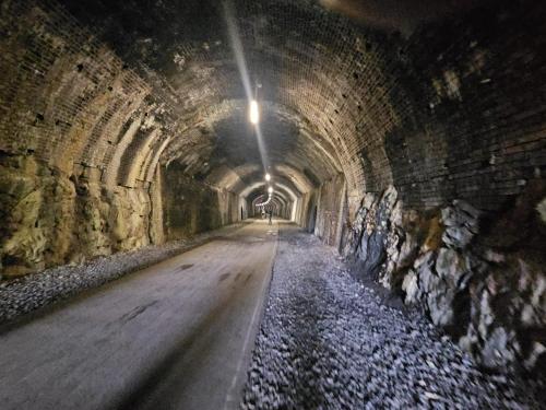 a long tunnel with a road in it at Rose Cottage - Cosy cottage in Millers Dale in Buxton