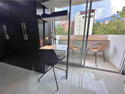 a room with a table and chairs on a balcony at Luxury Studio in El Poblado Modern Charm in Envigado