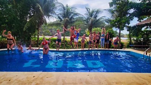 a group of people standing in a swimming pool at Lobo Hostel - Rurrenabaque in Rurrenabaque