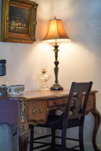a lamp sitting on top of a desk with a chair at Weaverville Hotel in Weaverville