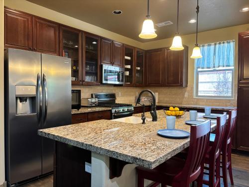 a kitchen with a granite counter top and stainless steel appliances at Fun & Peaceful Family Retreat in Flagstaff