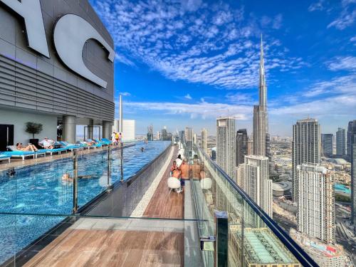 a pool on the top of a building with a view of the city at Highest infinity Pool in Downtown Dubai in Dubai