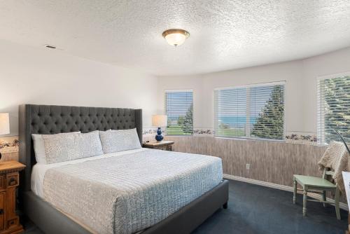 a bedroom with a bed and two windows at Tennis Building Condo #310 in Garden City