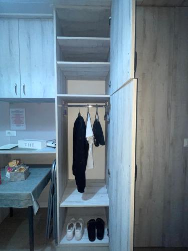 a closet with hangers and shoes in a room at Room V 1944 in Lamezia Terme