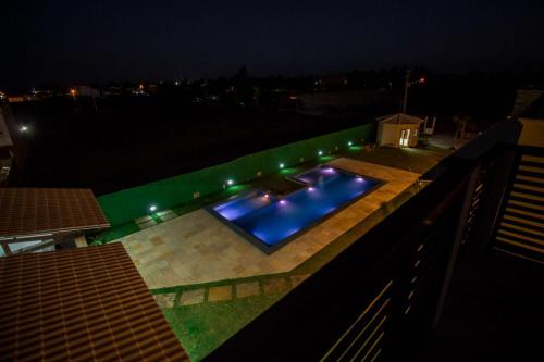 a swimming pool at night on a roof at Villa Coco Beach Preá in Prea