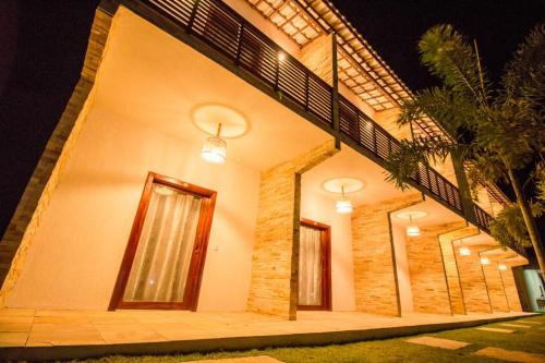 a building with lights on the side of it at Villa Coco Beach Preá in Prea