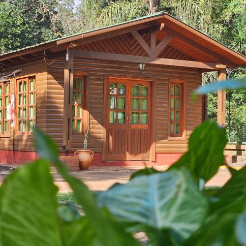 a small wooden cabin with a front door at Cabañas Rincon Santa Maria in Puerto Iguazú