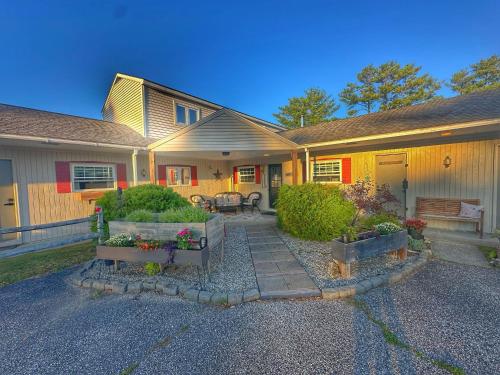 a house with two benches in the front yard at Brittany Motel in Sunderland