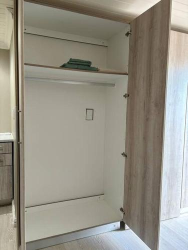 a closet with a white door in a room at Bachelor Flat B in Cape Town