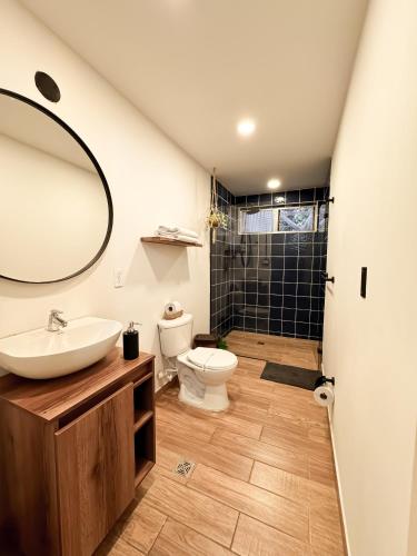 a bathroom with a sink and a toilet and a mirror at Alquiler apartamento amoblado en Laureles NID201 By Roots Rentals in Medellín