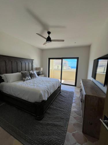 a bedroom with a bed and a flat screen tv at Golfers' Oasis Villa in Cabo San Lucas