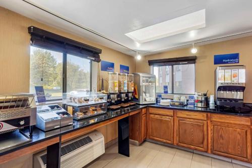 a large kitchen with a counter with many appliances at Best Western Monticello in Monticello