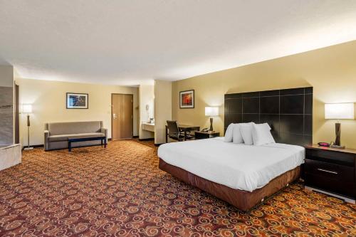 a hotel room with a large bed and a chair at Best Western Monticello in Monticello