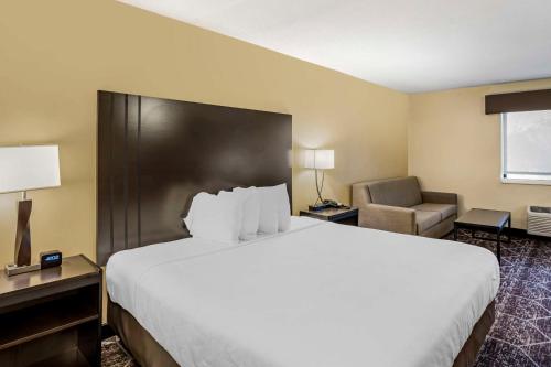a hotel room with a large bed and a chair at Best Western Monticello in Monticello