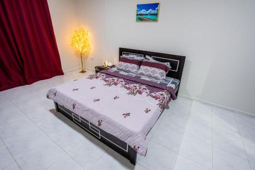 a bedroom with a large bed in a room at tourist Family and couple private Rooms ME11 BGR 01 baith al jannah LLC one private room in three bedroom apartment in Abu Dhabi