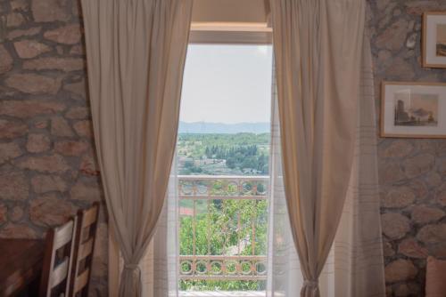 a window with curtains in a room with a view at Villa Madunic with private swimming pool in Cista Provo