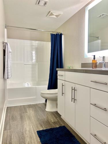 a bathroom with a toilet and a tub and a sink at Stunning 2BD 2BTH Apt in Santa Monica! in Los Angeles