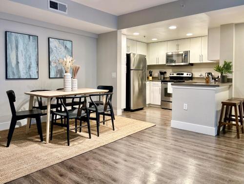 a kitchen and dining room with a table and chairs at Stunning 2BD 2BTH Apt in Santa Monica! in Los Angeles