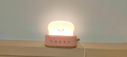 a small pink candle with a ghost face on it at Zhuge Hospitality Homestay in Tainan