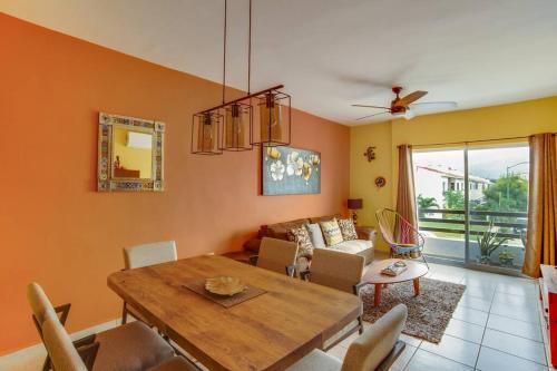 a living room with a table and a couch at 2 BR Condo with pool only 15 min to Marina & Beach in Palmar