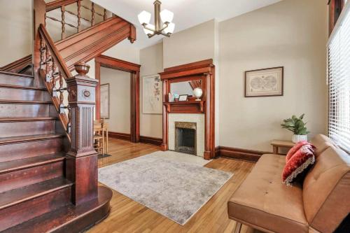 a living room with a staircase and a fireplace at 4 Bed Duplex near Goodale Park in Columbus