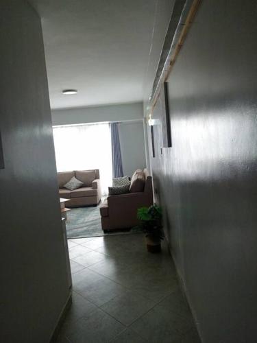 a hallway leading to a living room with a couch at Golden Nest in Lake View Estate