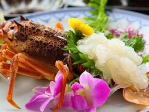 a plate of food with rice and flowers on it at 城下町に佇む癒しの宿 旅館 大政 in Karatsu