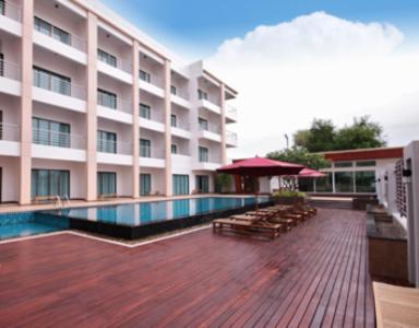 a large building with a swimming pool in front of it at Paragon Suites Resort in Jomtien Beach