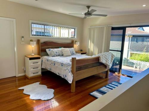a bedroom with a bed and a window at Tasman Sea View Bonny Hills in Bonny Hills