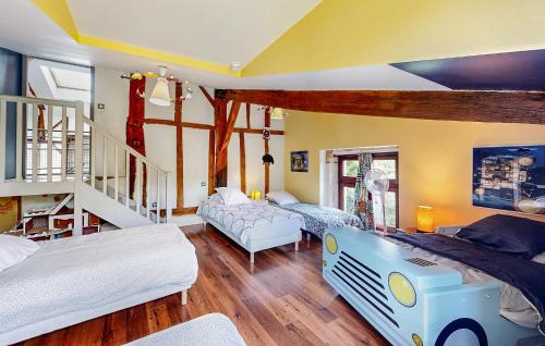 a bedroom with two beds and a stair case at Stunning Home In Ossages in Ossages