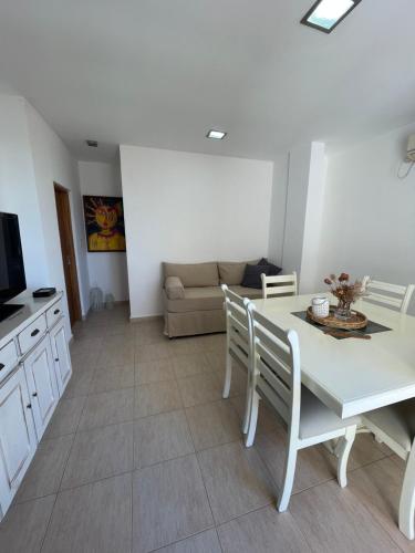 a living room with a table and chairs and a couch at Departamento Céntrico Resistencia in Resistencia
